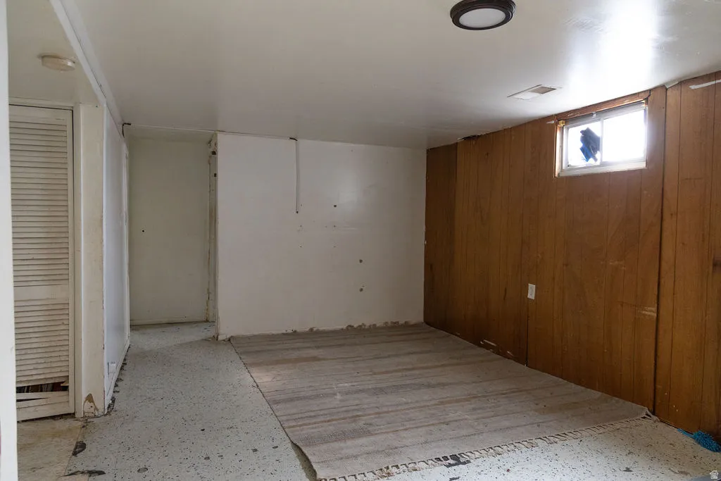 Basement featuring wooden walls