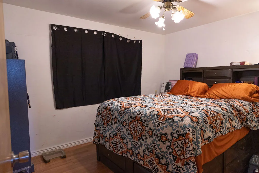Bedroom featuring wood finished floors and ceiling fan
