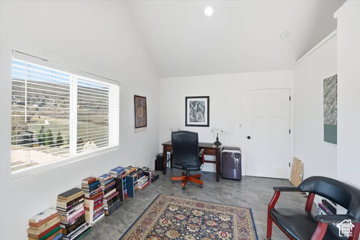 Bedroom/Office space featuring lofted ceiling with access to balcony