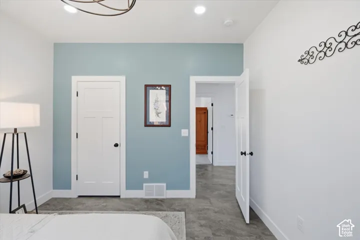 Bedroom with baseboards and suspended lighting