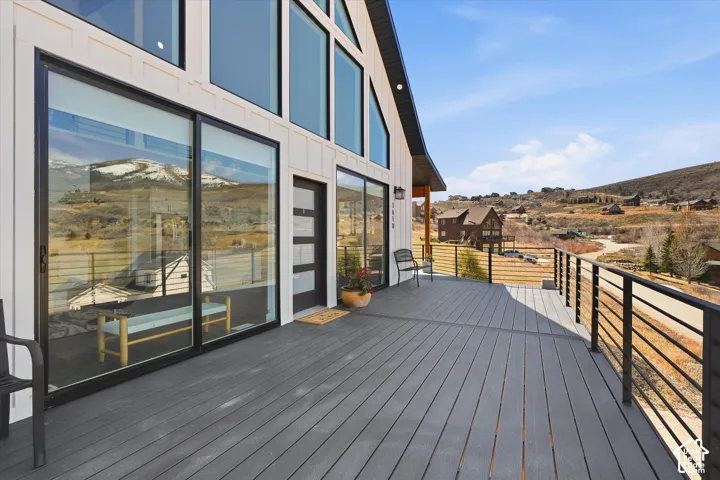 Deck with a mountain view and a residential view
