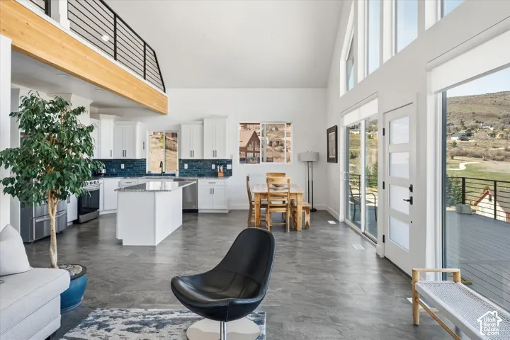 Living area with a high ceiling and healthy amount of natural light