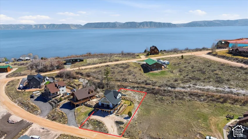 Aerial perspective of suburban area featuring property parcel outlined and a water and mountain view