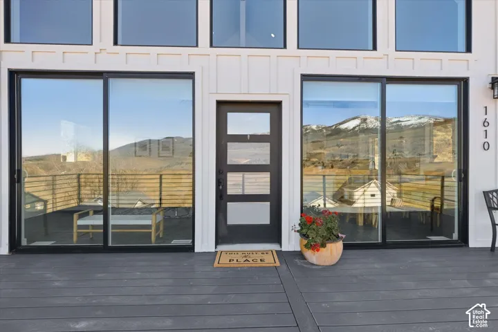 Doorway to property featuring board and batten siding and a mountain view