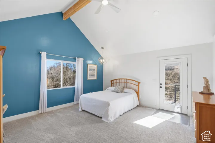 Primary Suite Bedroom with light carpet, a ceiling fan, and access to exterior