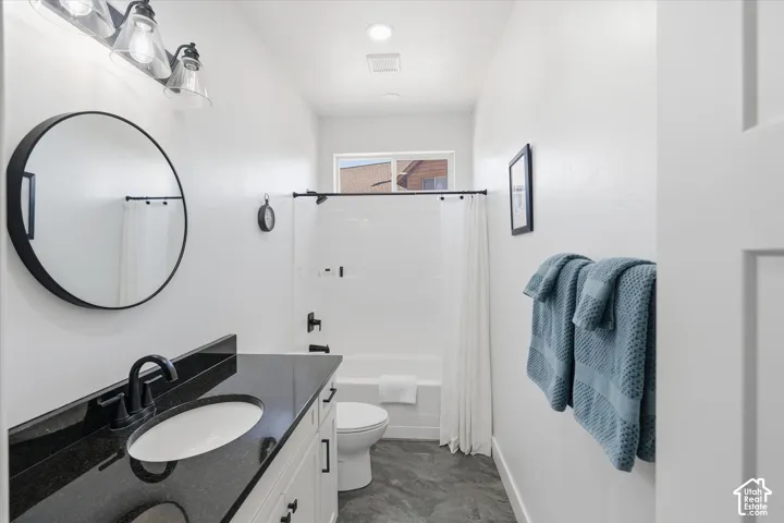 Bathroom with vanity and shower / bath combination with curtain