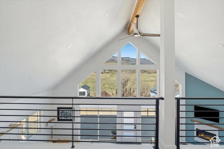 Detailed view of beamed ceiling, a mountainous background, and ceiling fan