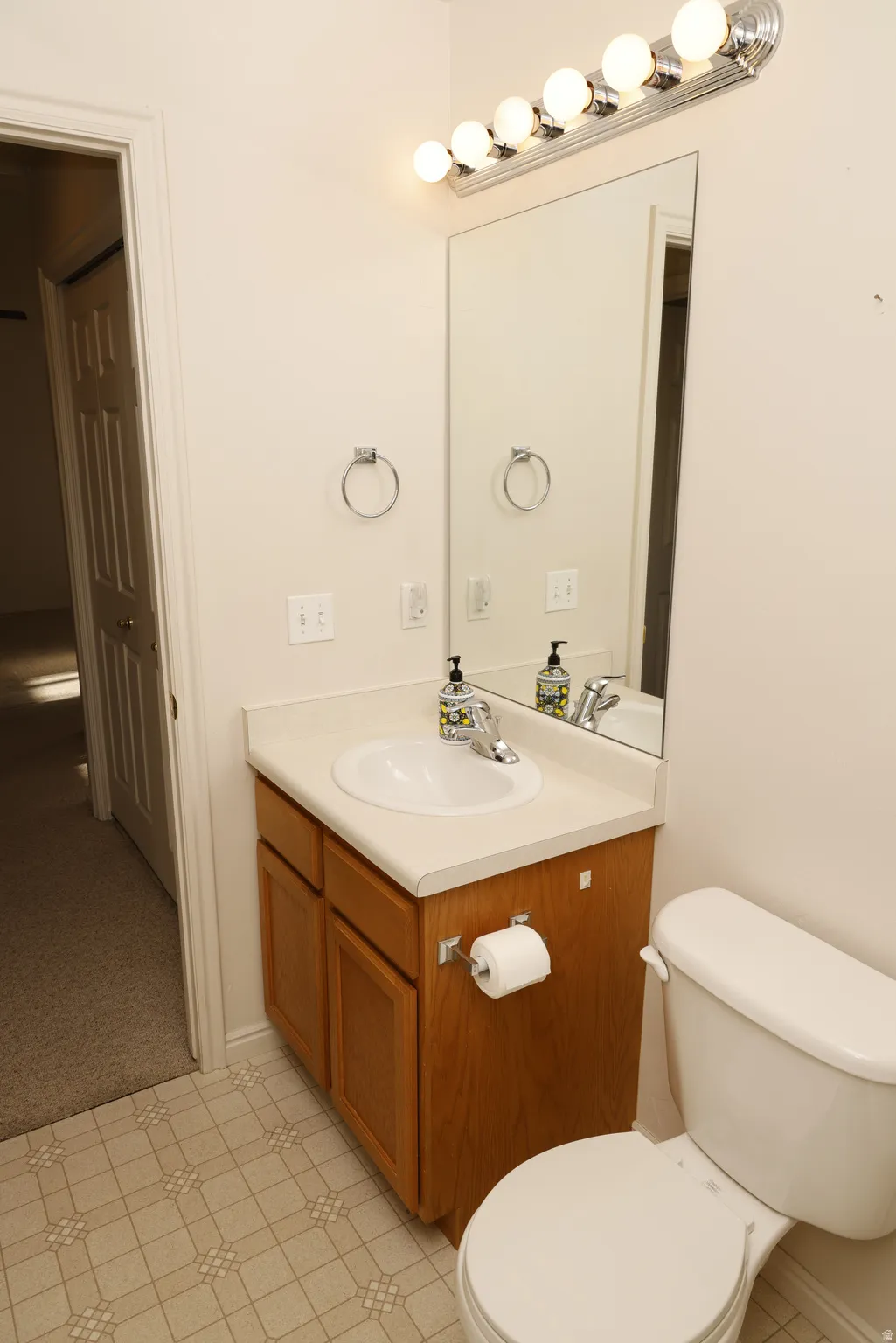 Half bath featuring toilet and vanity