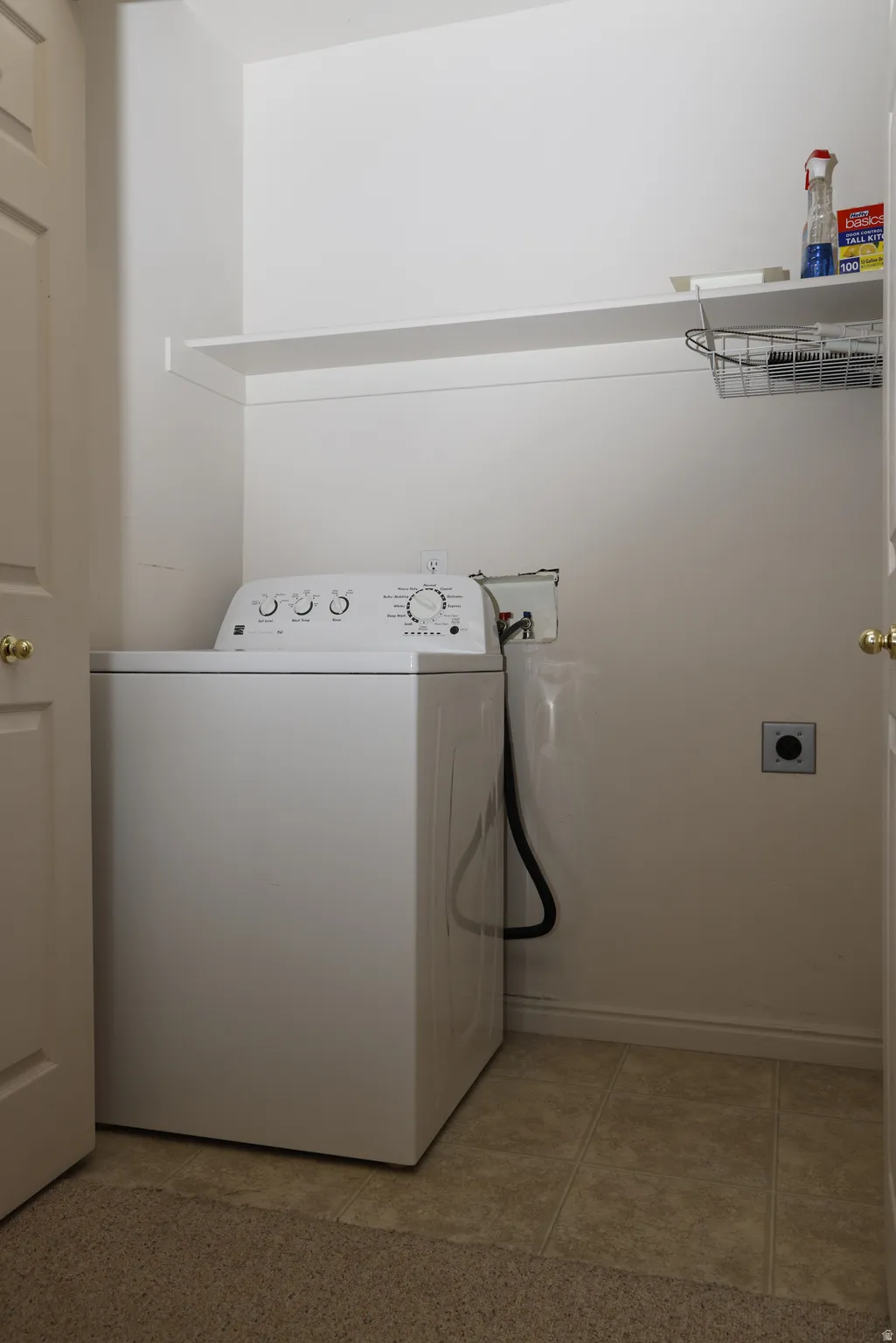 Laundry area with washer / clothes dryer and light tile patterned flooring