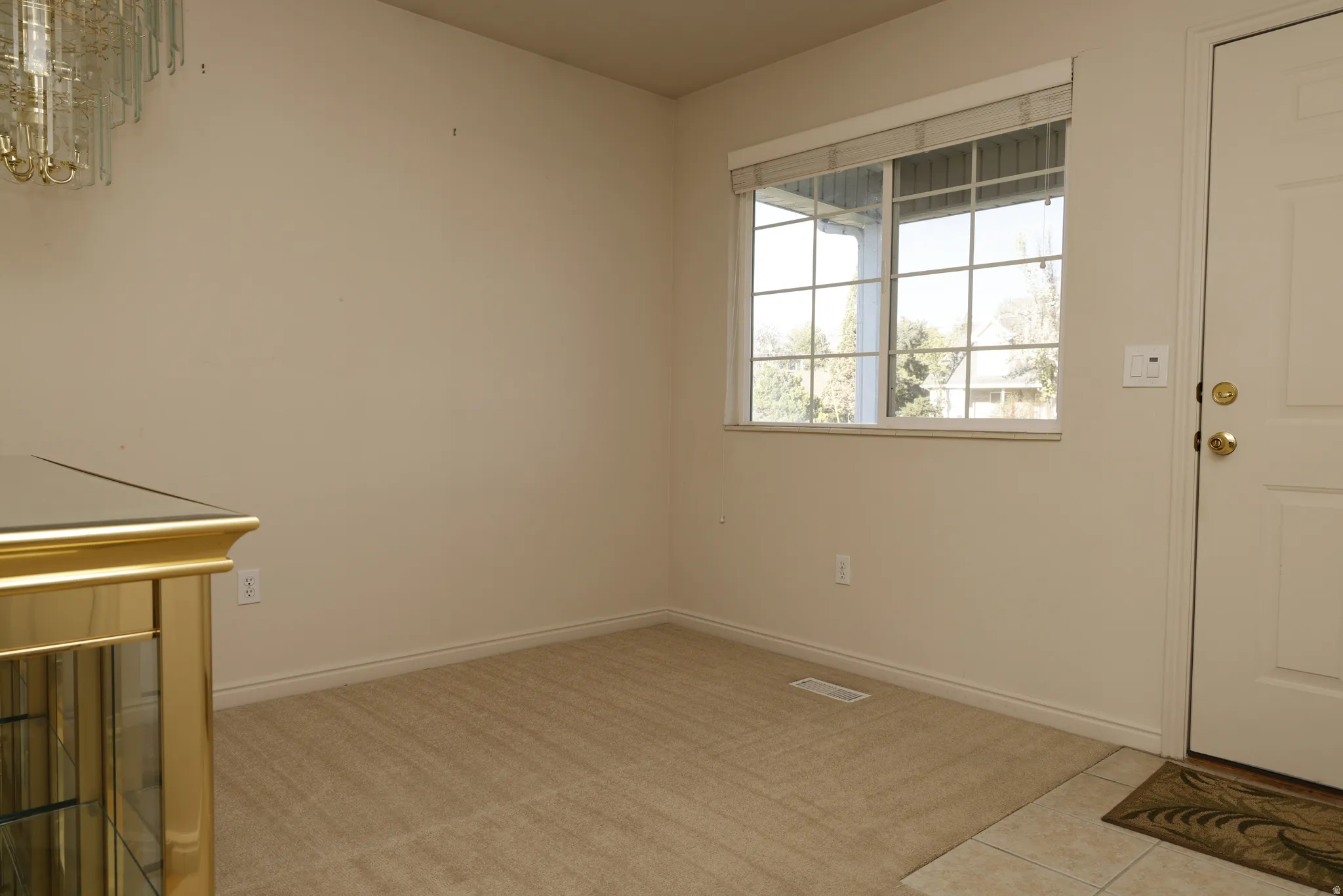 Interior space featuring light tile patterned flooring and baseboards