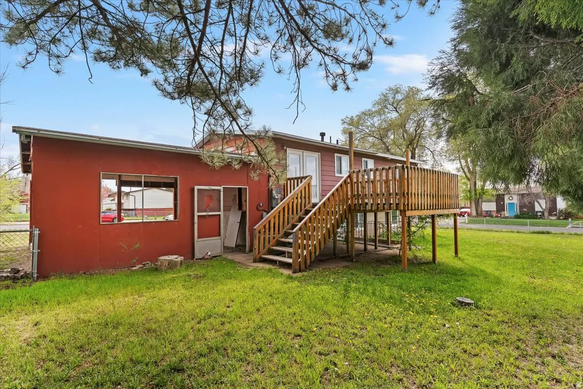 Back of property featuring stairway and stucco siding
