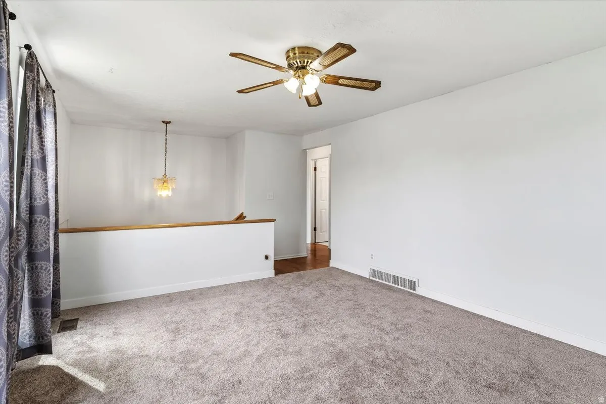 Unfurnished room with carpet floors and ceiling fan