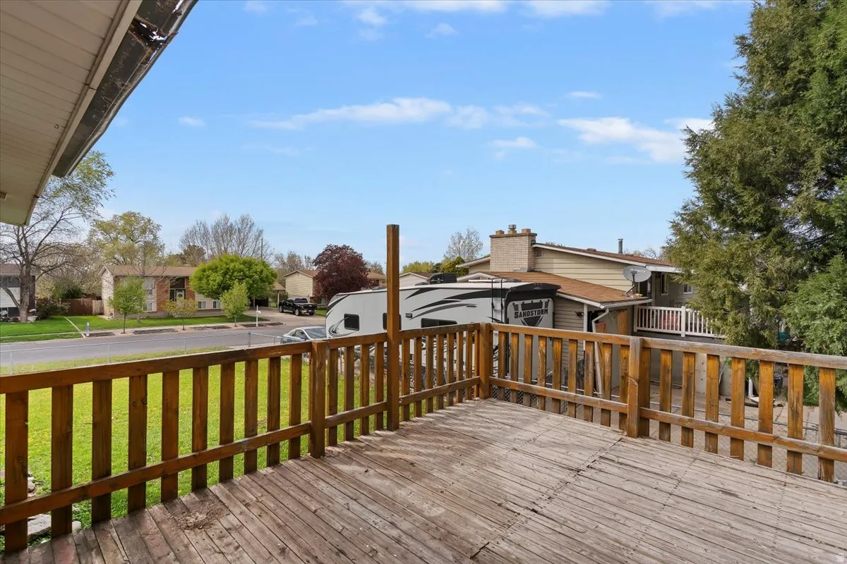 Wooden terrace with a residential view and a yard