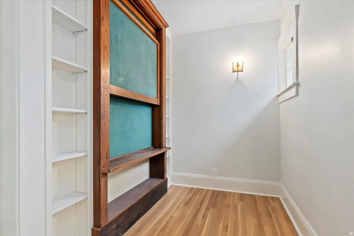 Interior space featuring ornamental molding and light wood-type flooring