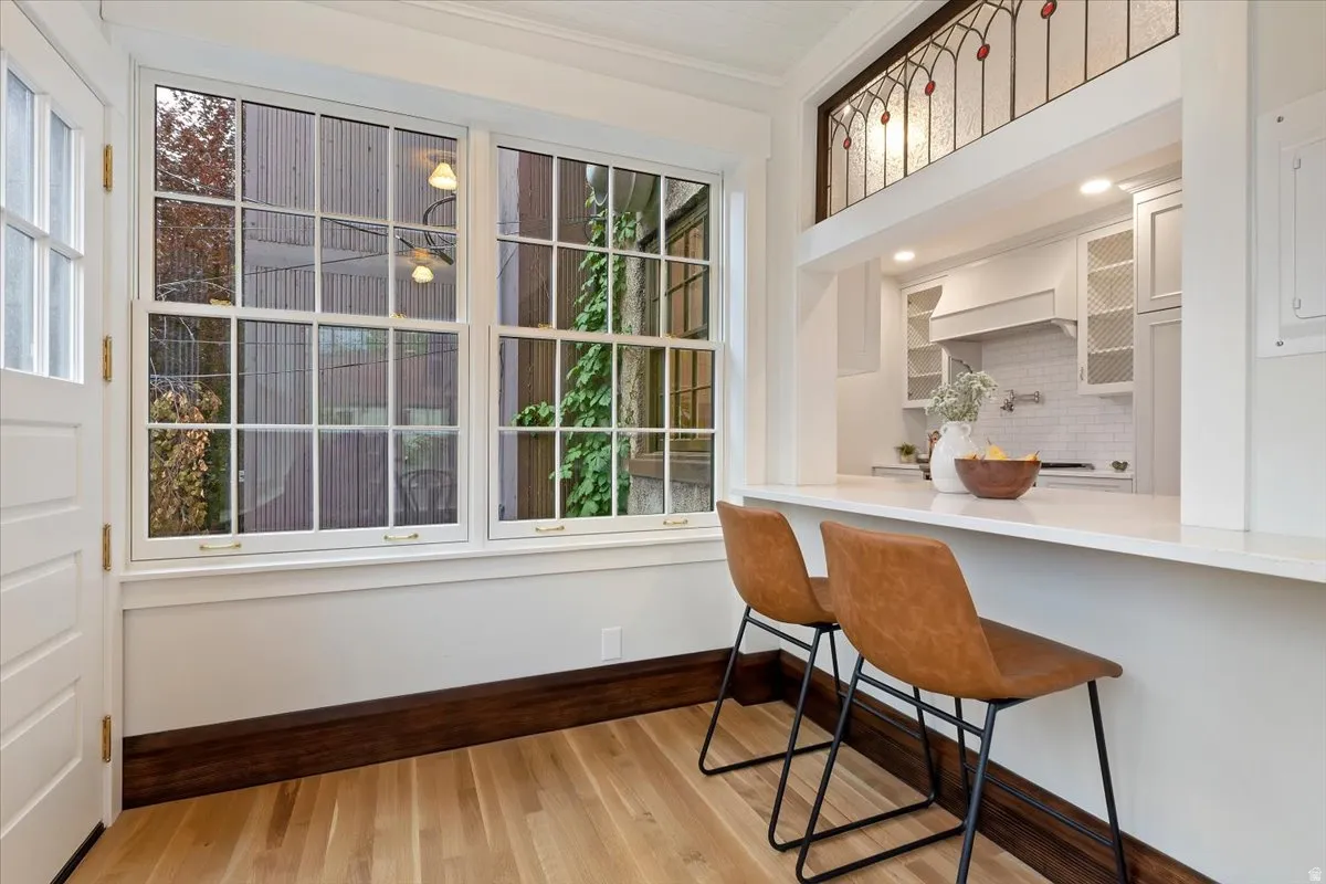 Dining room featuring light wood-style floors and ornamental molding