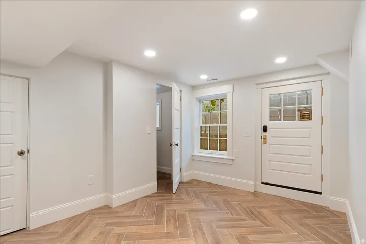 Entryway featuring parquet flooring and recessed lighting