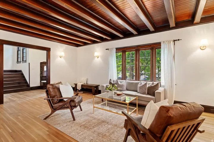 Living area featuring wood finished floors and beamed ceiling