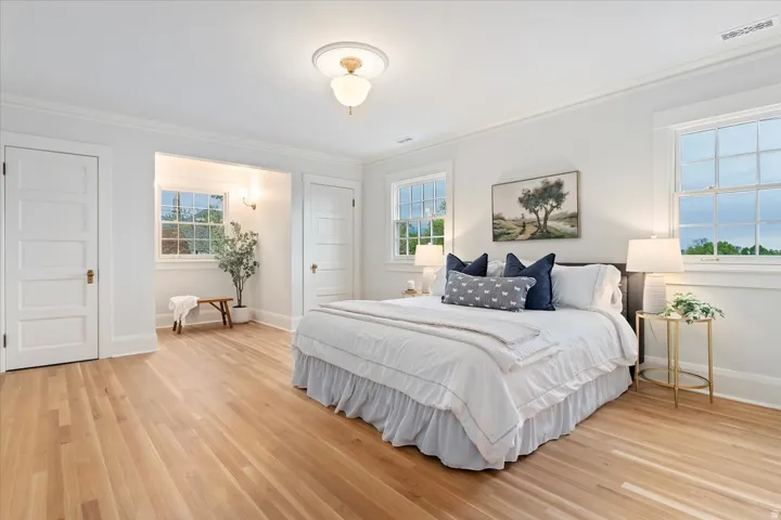Bedroom featuring light wood-style floors and ornamental molding