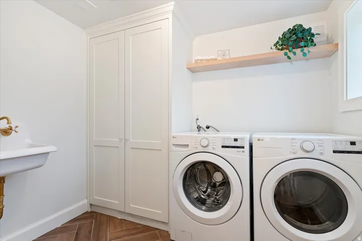 Laundry room with parquet floors and separate washer and dryer