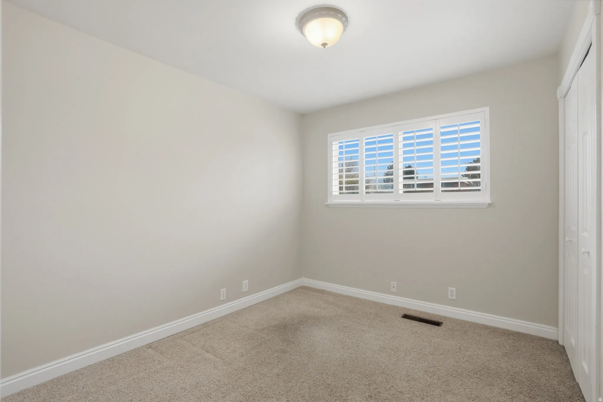 Unfurnished bedroom featuring a closet and carpet floors