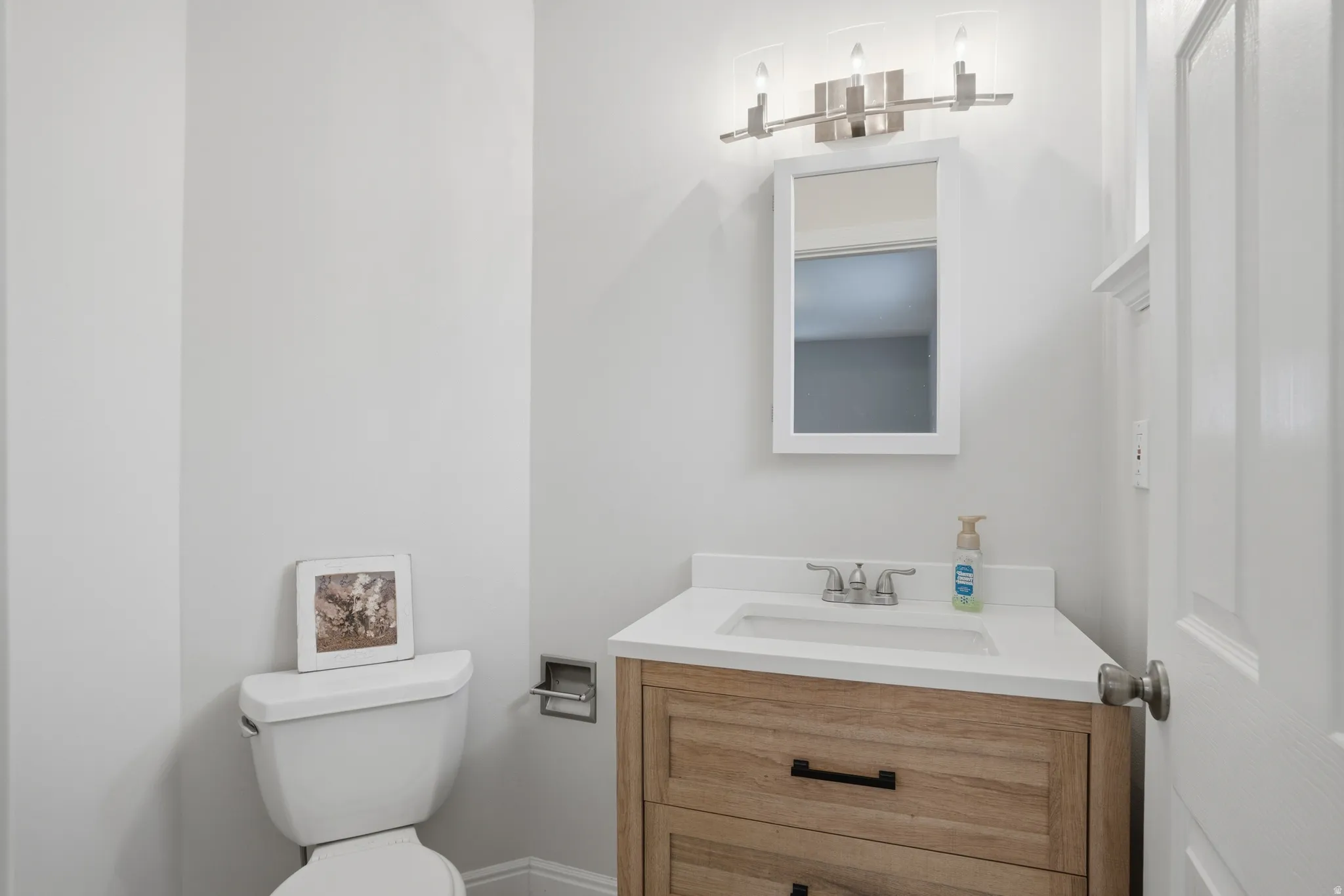 Half bath with vanity and toilet
