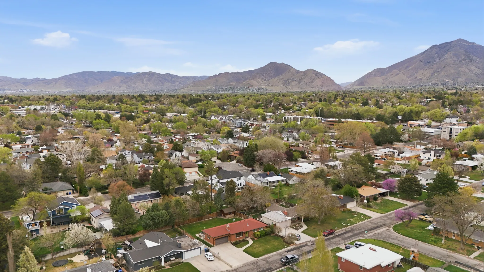 Aerial perspective of suburban area featuring a mountainous background