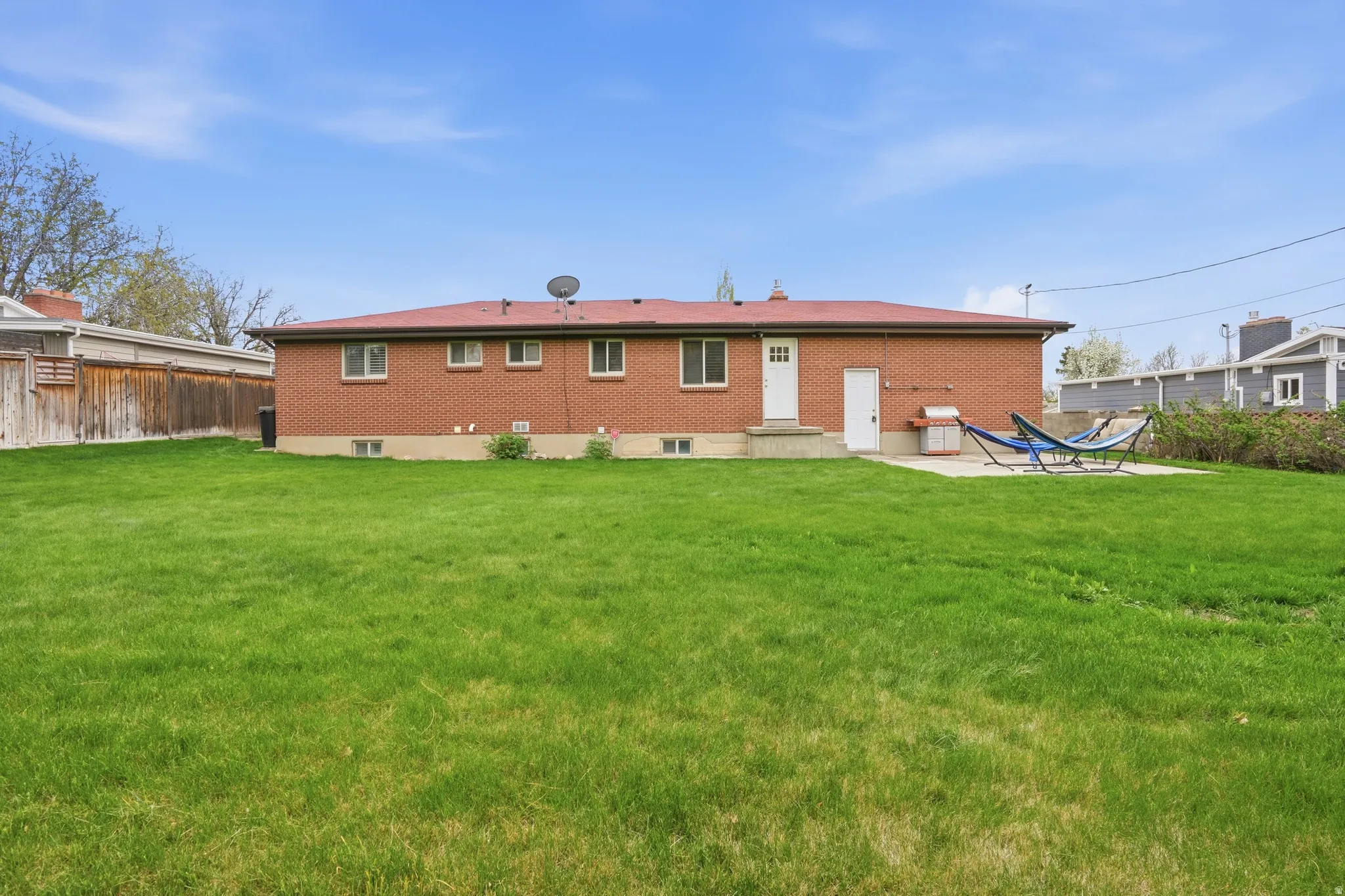Rear view of house with a patio area and brick siding