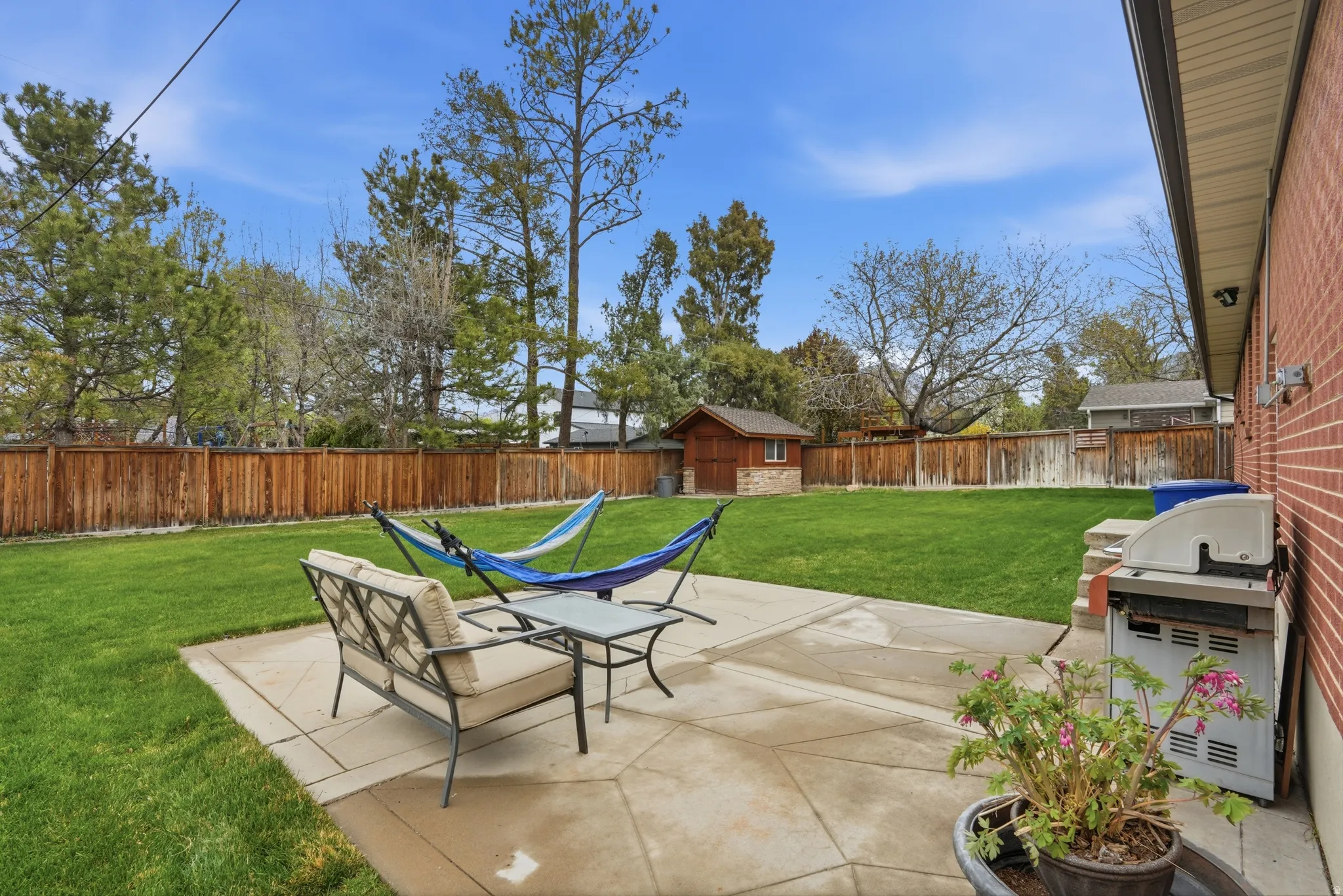 Fenced backyard with a patio area and area for grilling