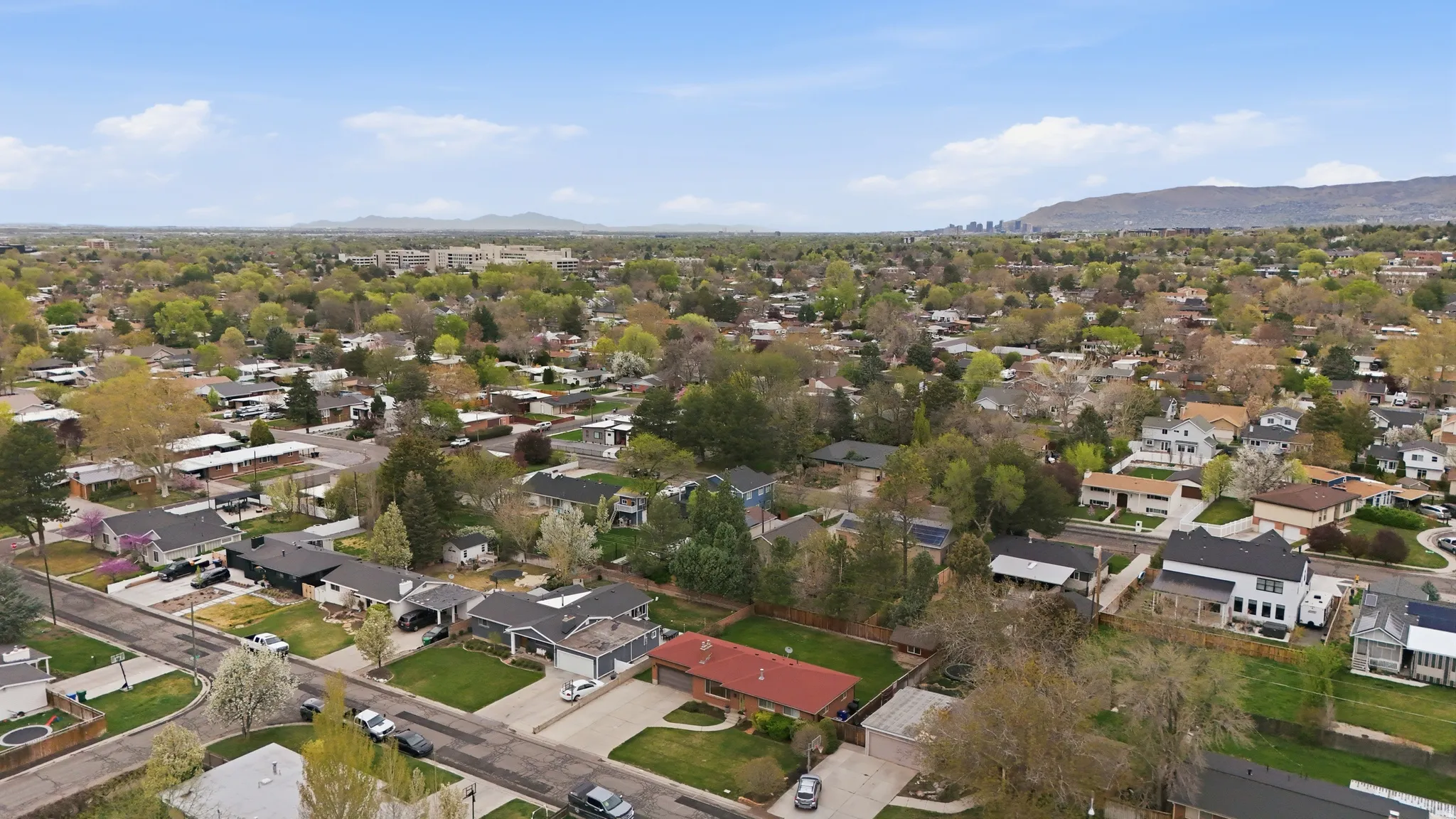 Aerial perspective of suburban area featuring a mountainous background