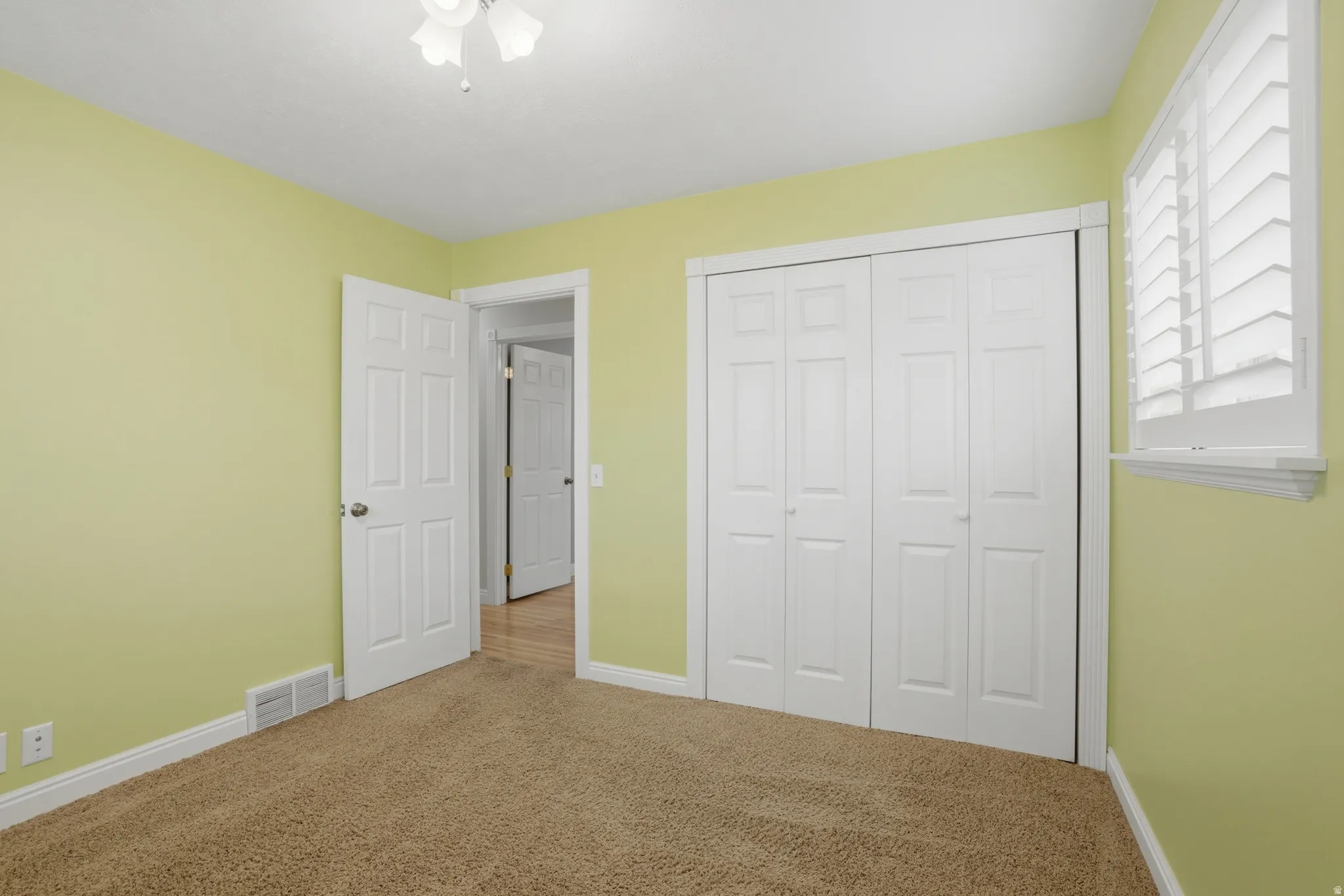 Unfurnished bedroom featuring carpet floors and a closet