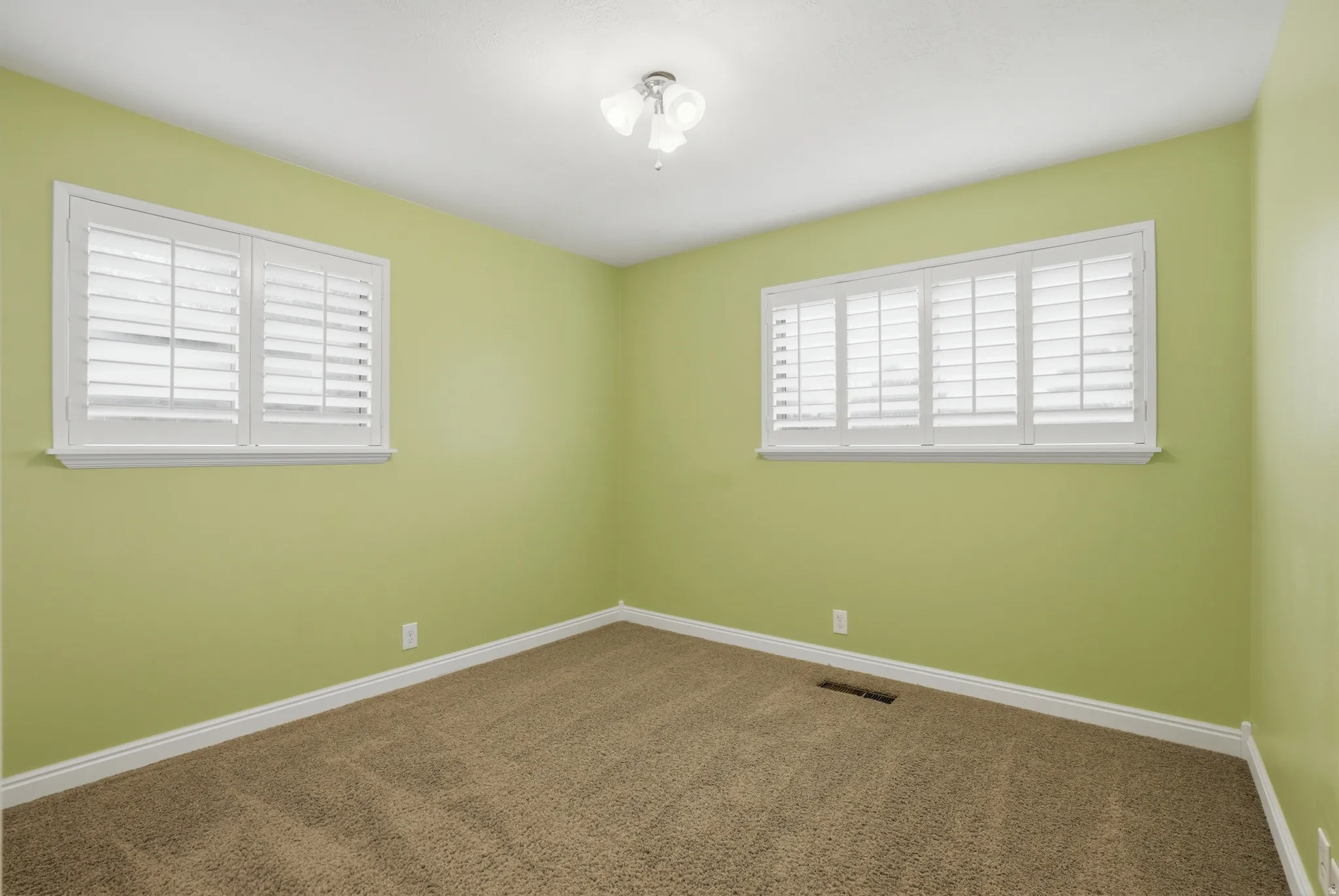 Unfurnished bedroom featuring baseboards and dark carpet