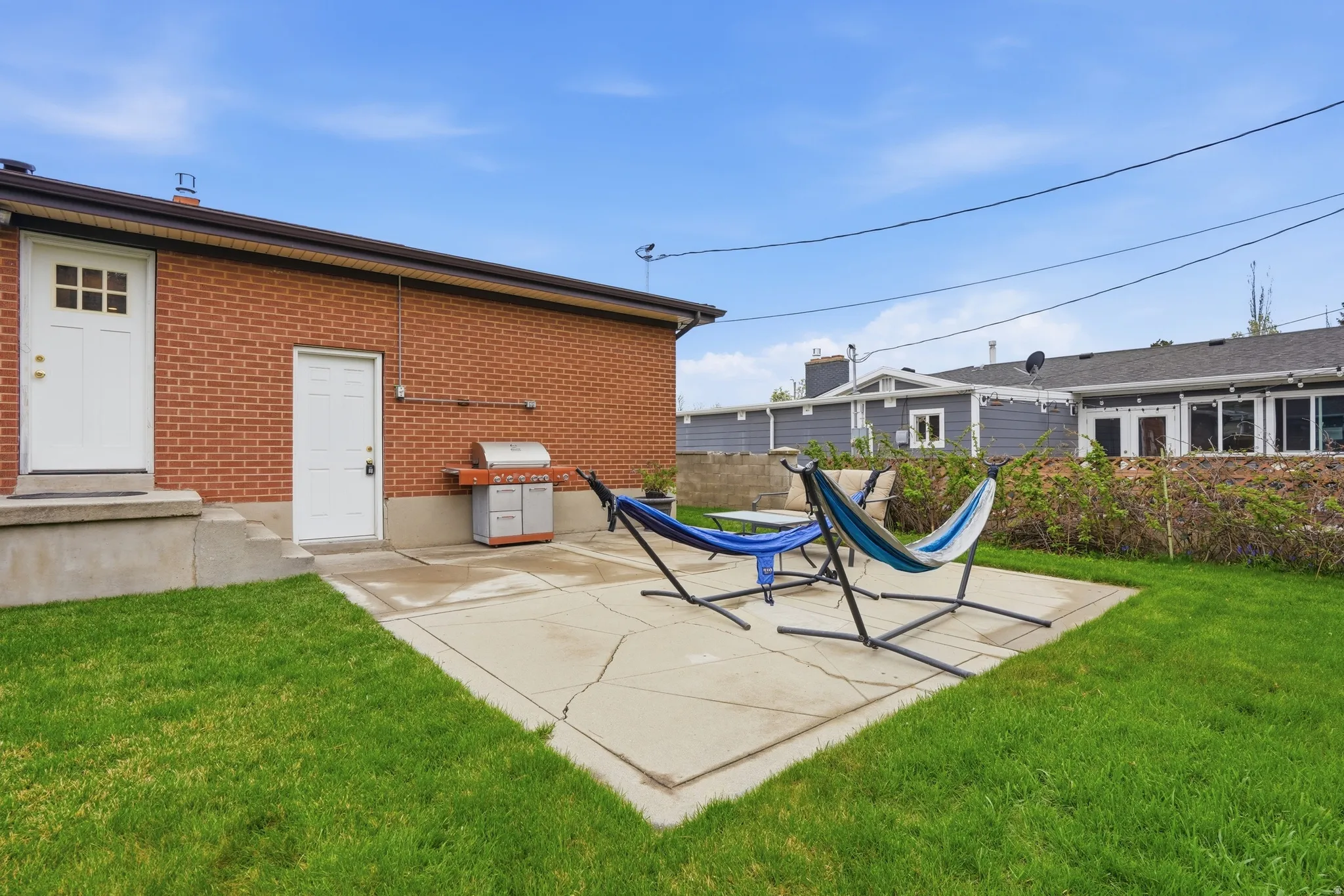 Back of property with a patio and brick siding