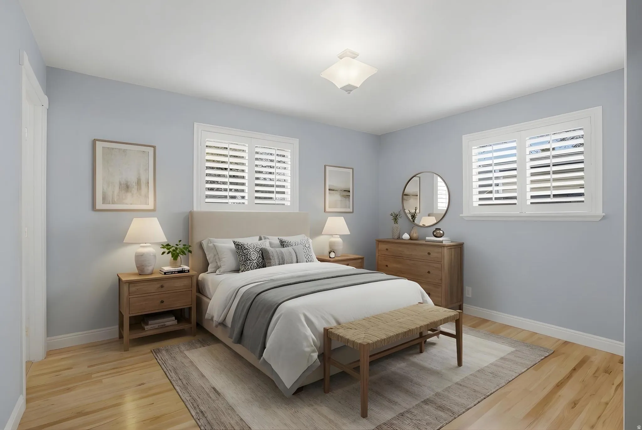 Bedroom featuring light wood finished floors virtually staged.