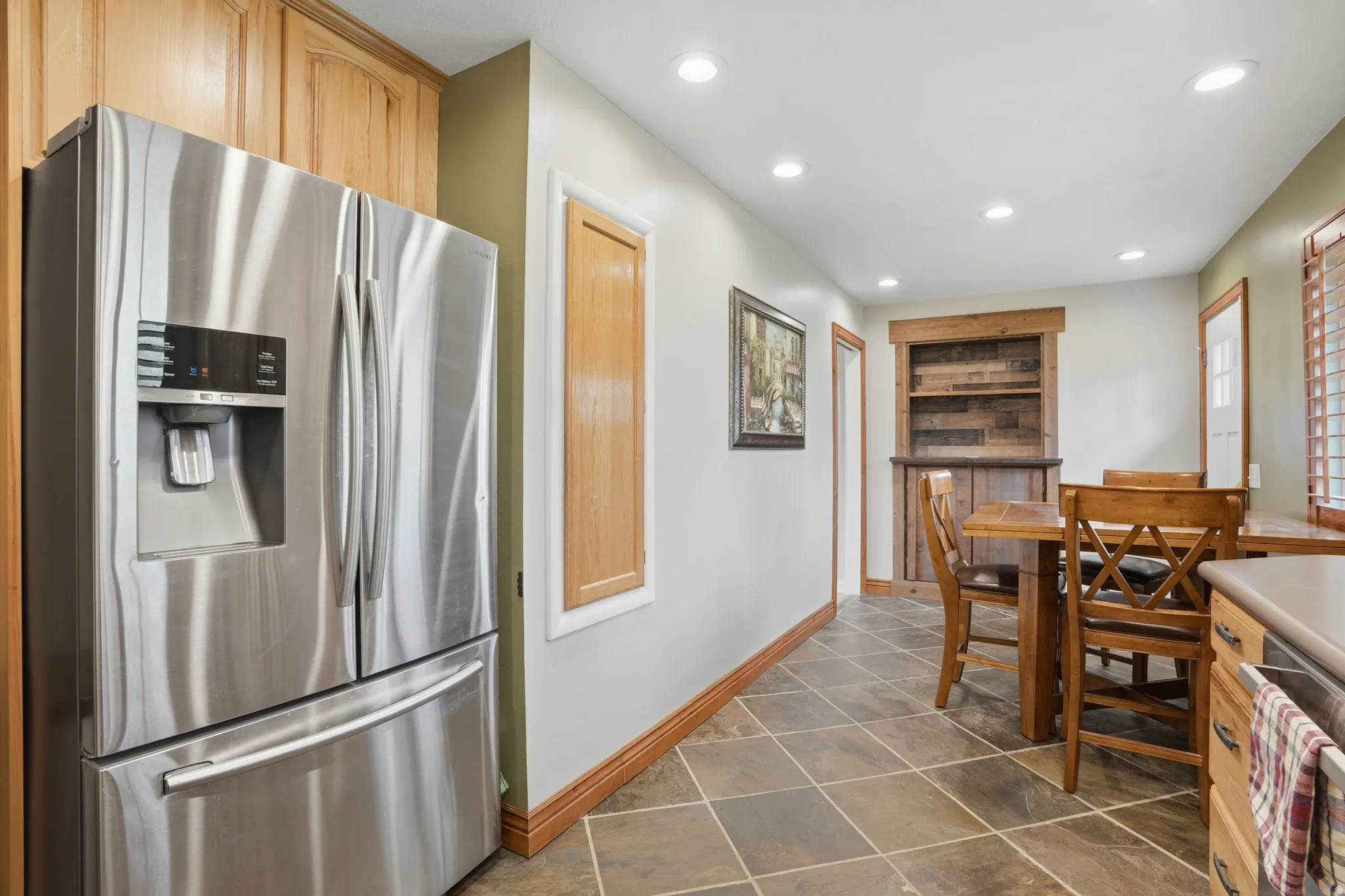 Kitchen featuring stainless steel appliances, recessed lighting, light wood finish cabinetry, and light countertops