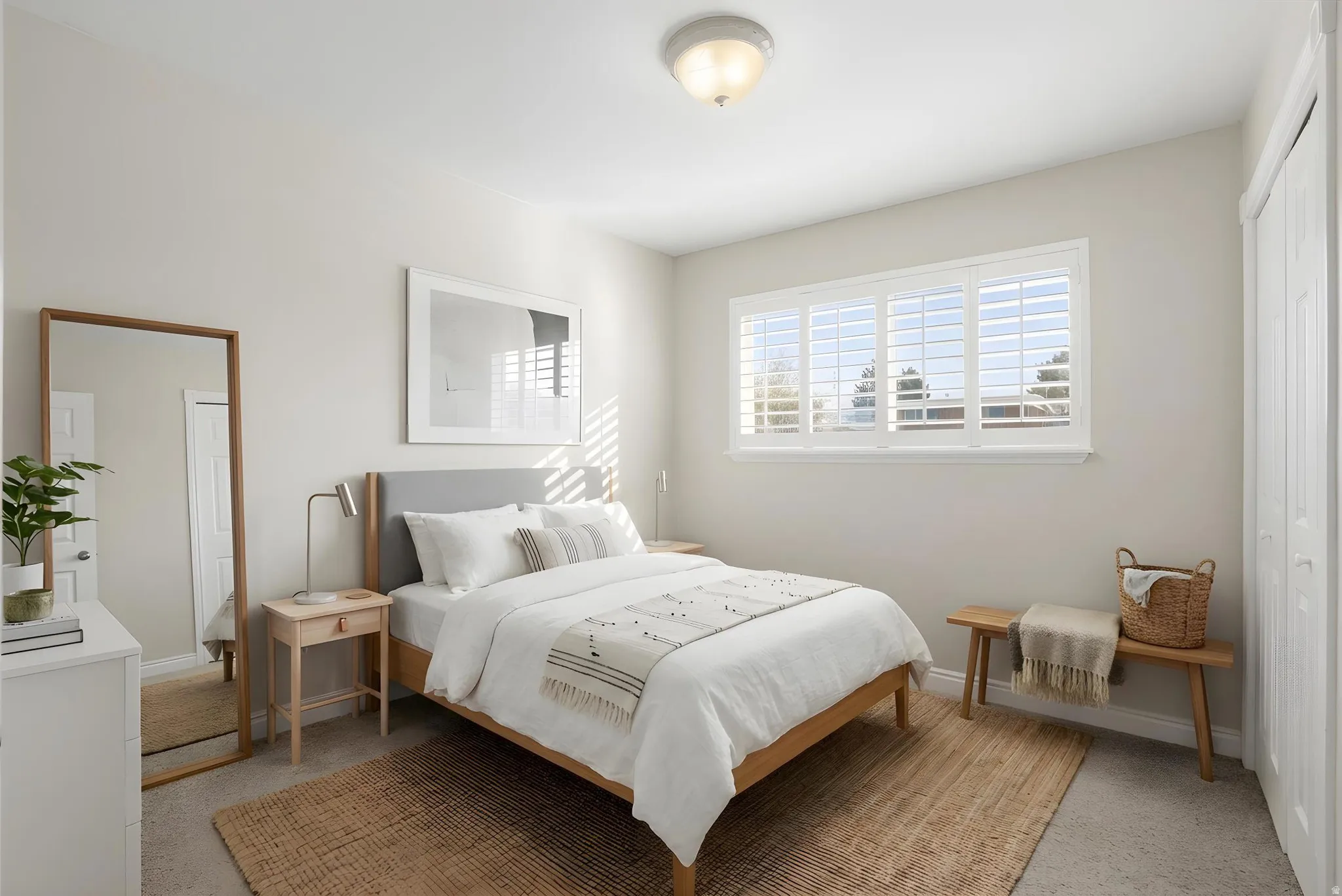 Bedroom with a closet and light colored carpet Virtually staged.