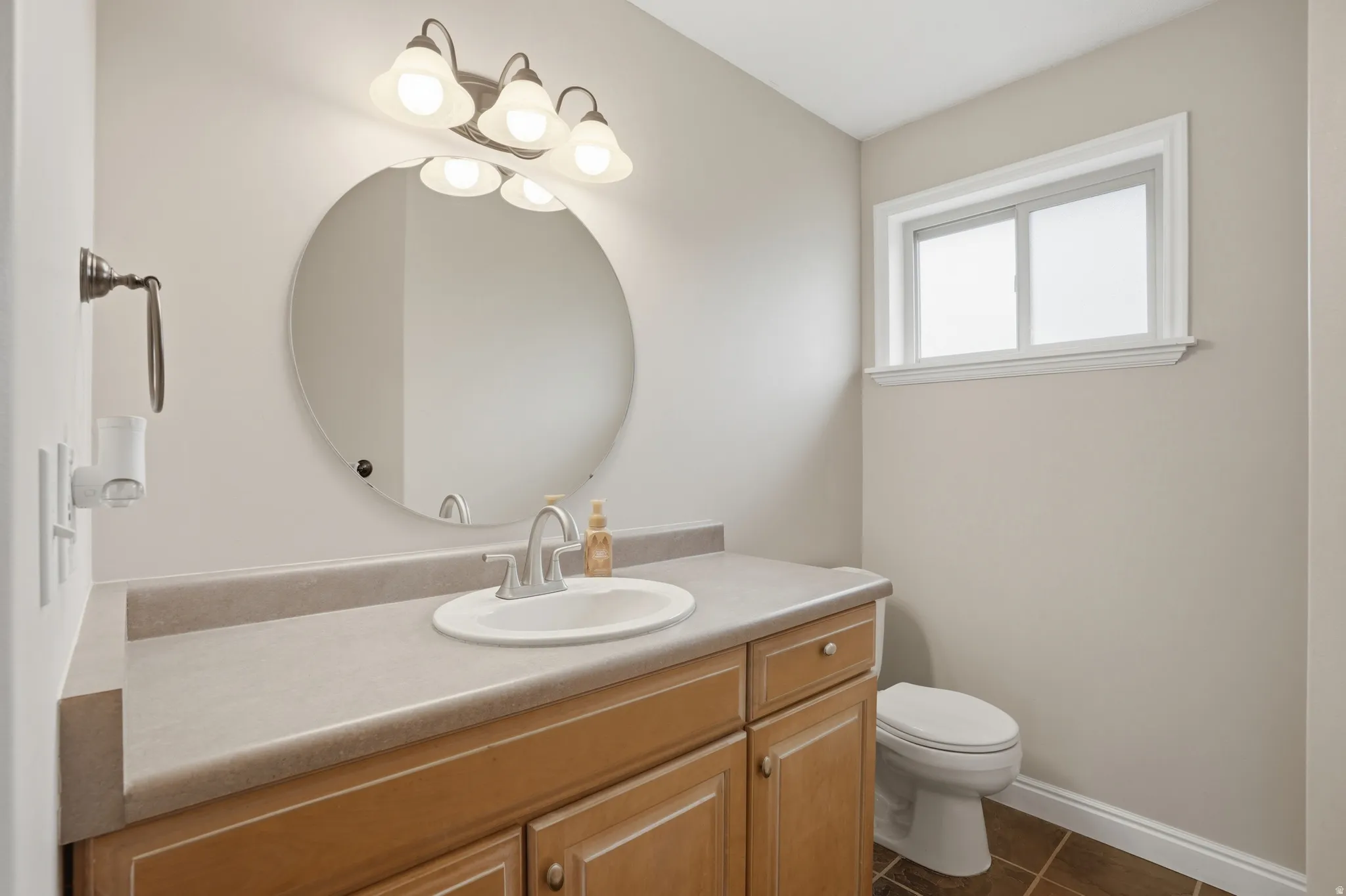 Full bathroom featuring vanity and dark tile patterned floors