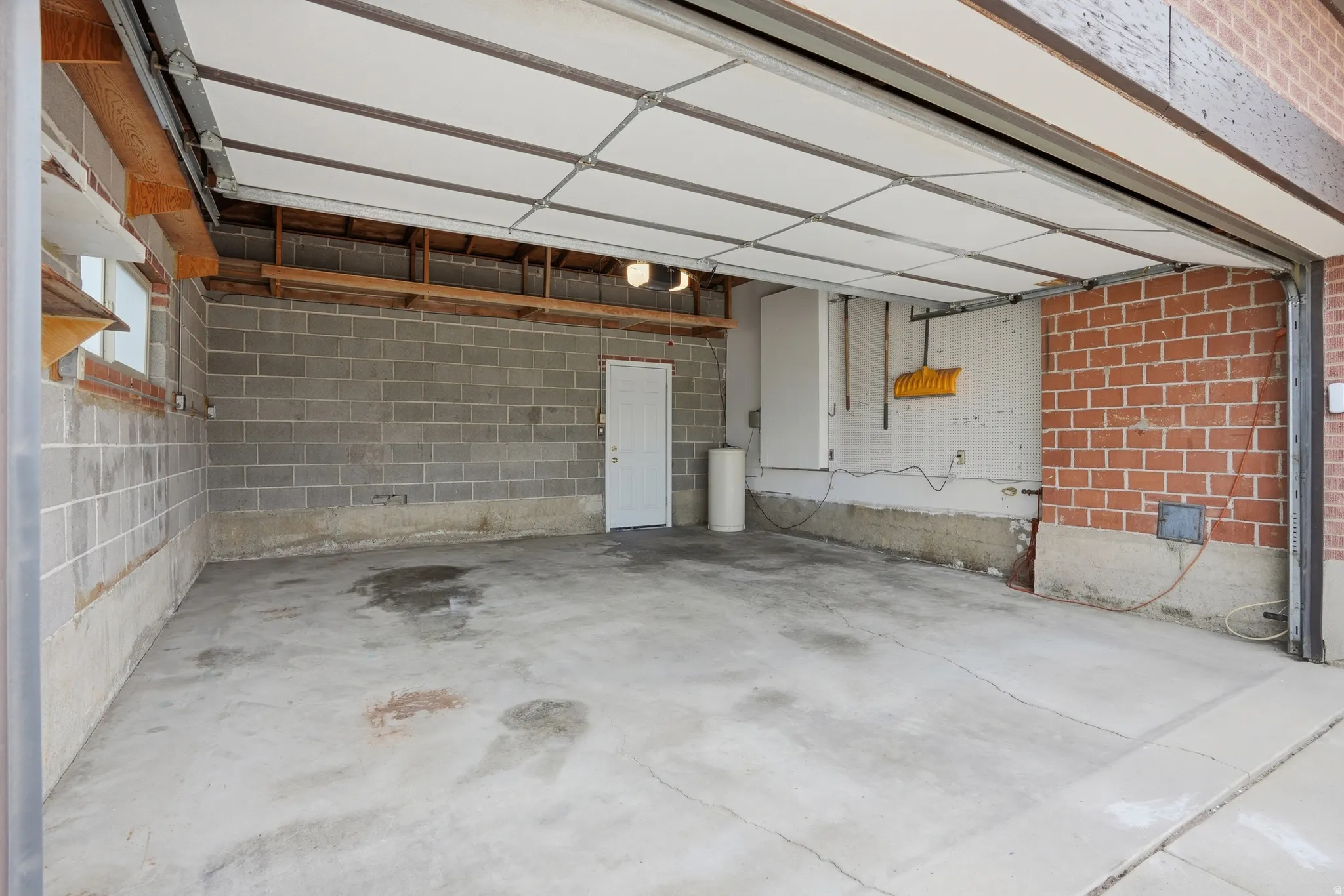 Garage featuring concrete block wall