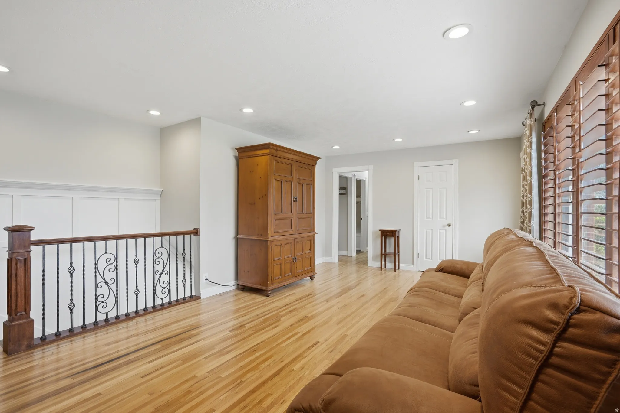 Living area featuring light wood-style flooring and recessed lighting