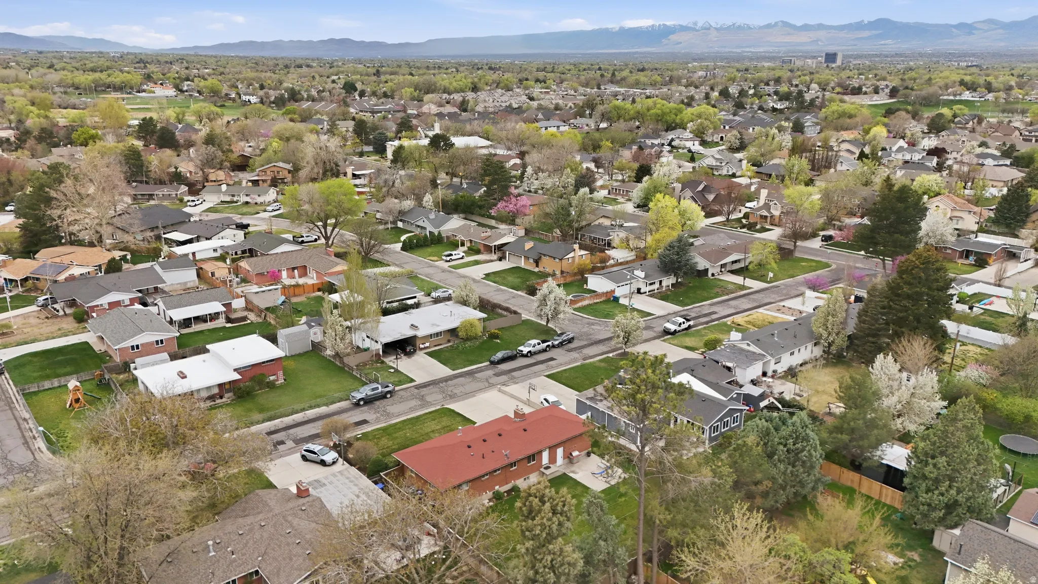 Aerial overview of property's location with a mountain backdrop and nearby suburban area
