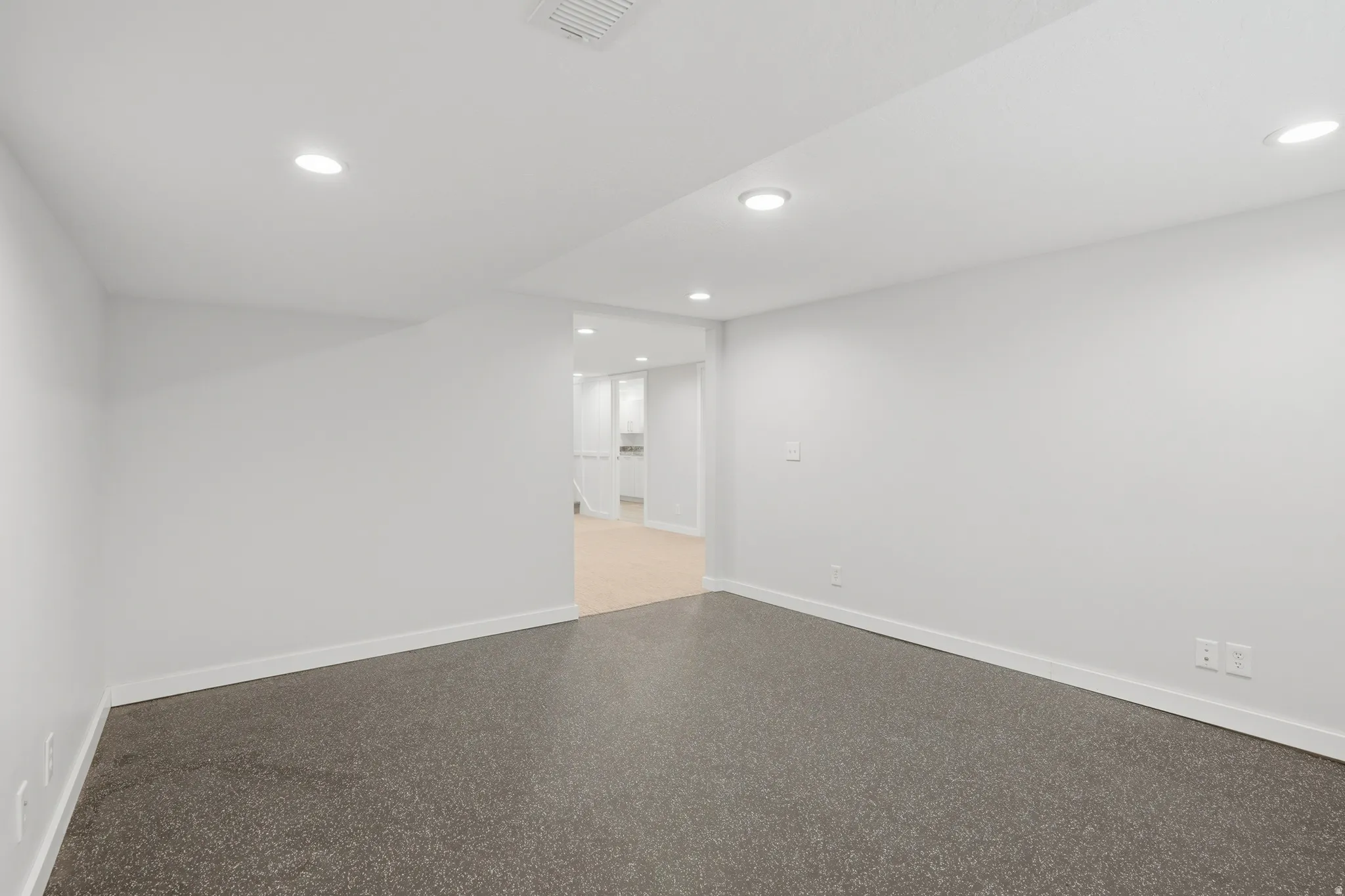 Exerecise room featuring recessed lighting and speckled floor