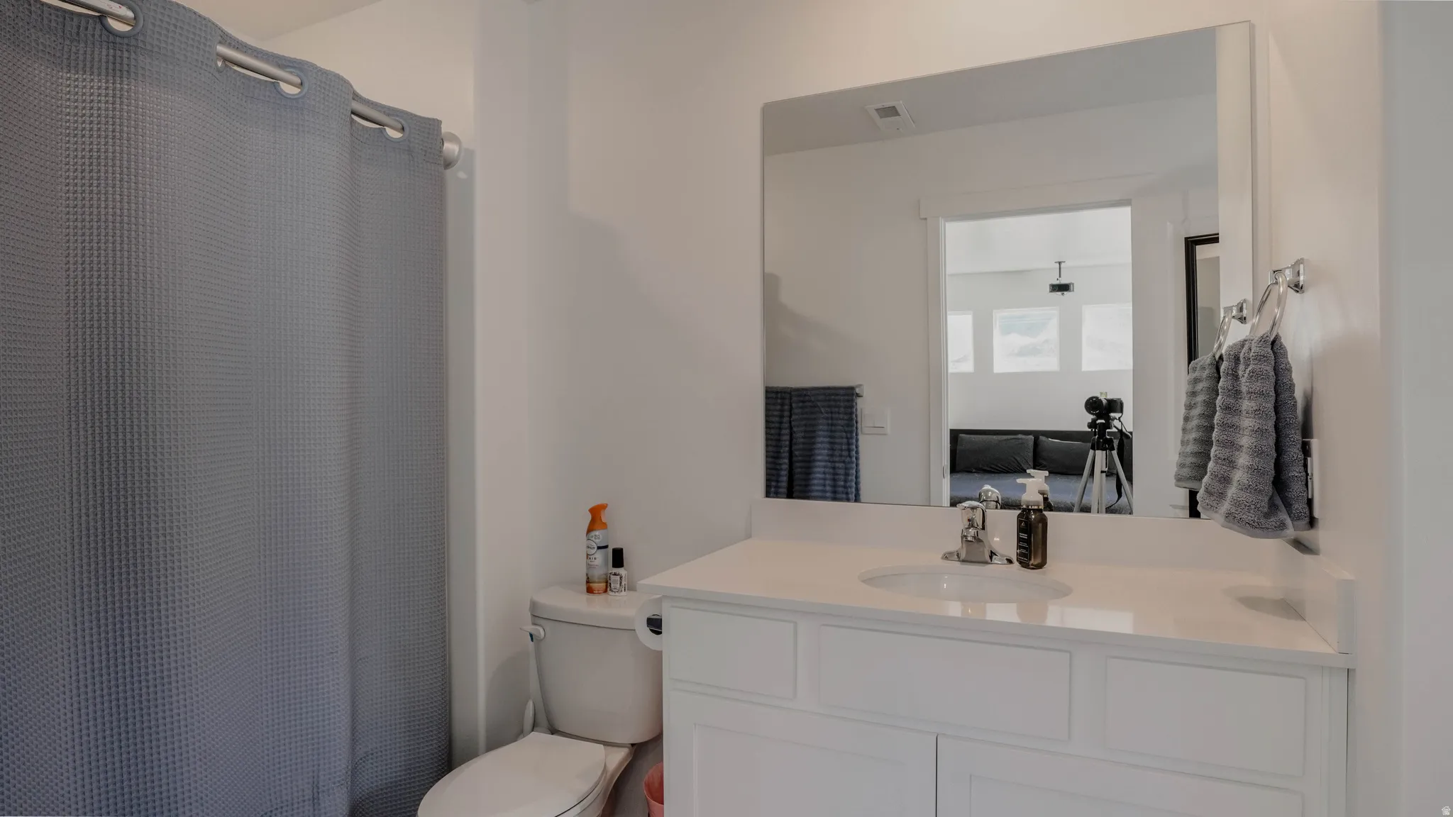 Full bath featuring vanity, curtained shower, and ensuite bath