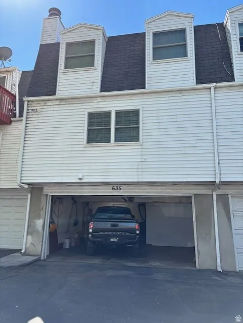 View of back side of home - garage entrance.