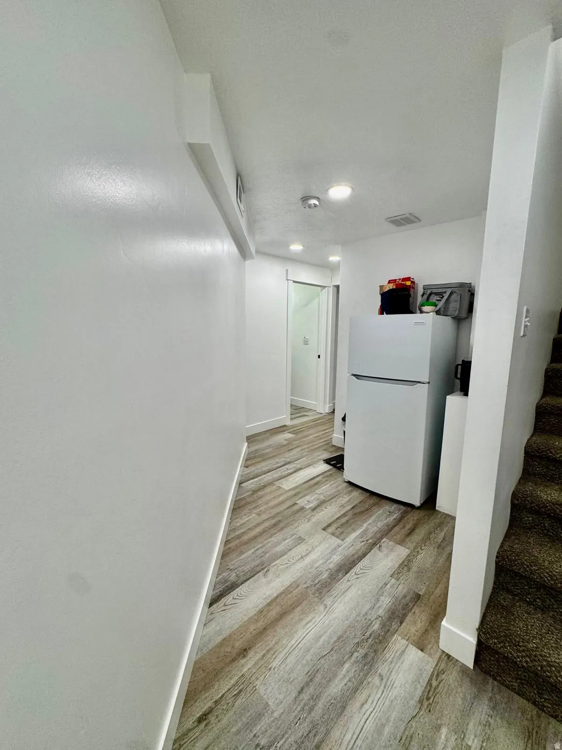 Corridor featuring light wood-style flooring and recessed lighting