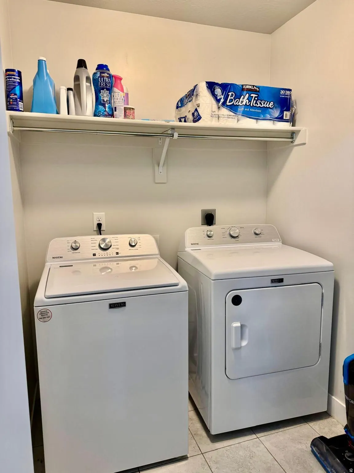 Laundry room with washer and dryer and light tile patterned floors
