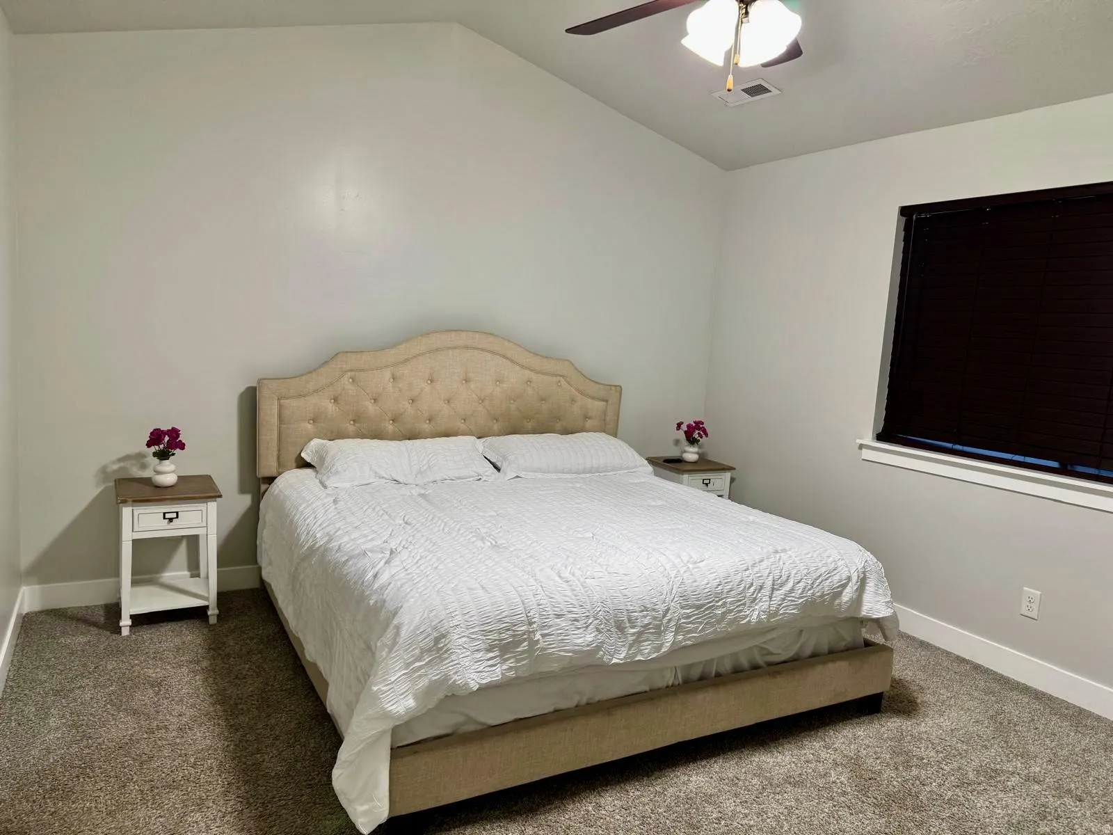 Bedroom with carpet flooring, ceiling fan, and lofted ceiling