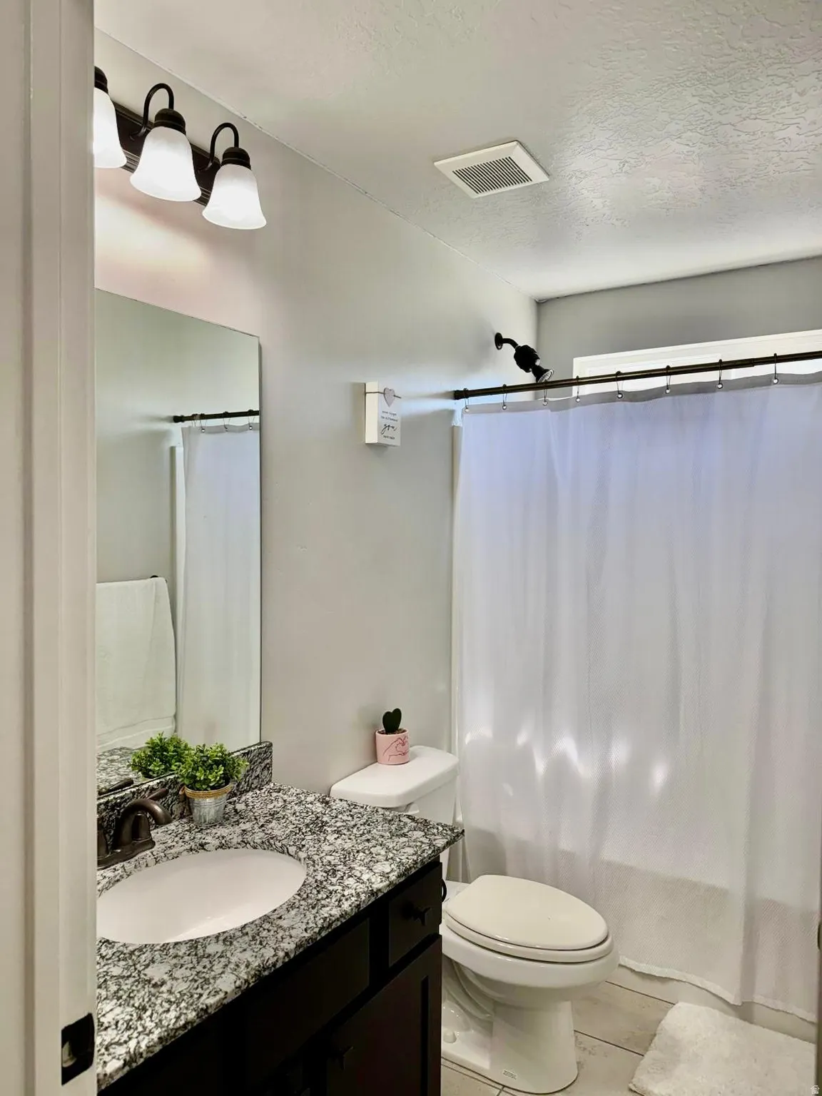 Bathroom featuring vanity and a textured ceiling