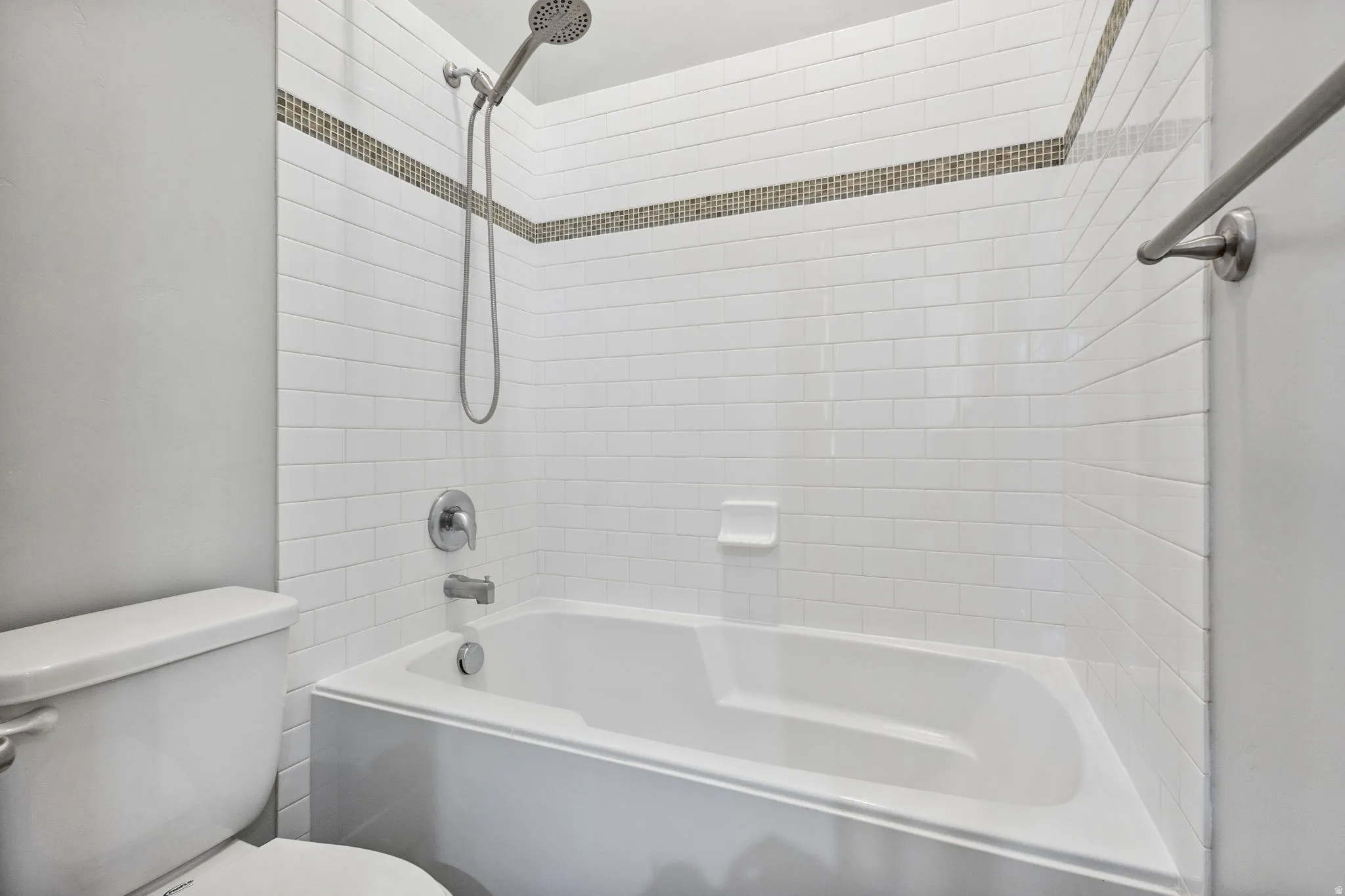 Full bathroom with toilet and tub / shower combination