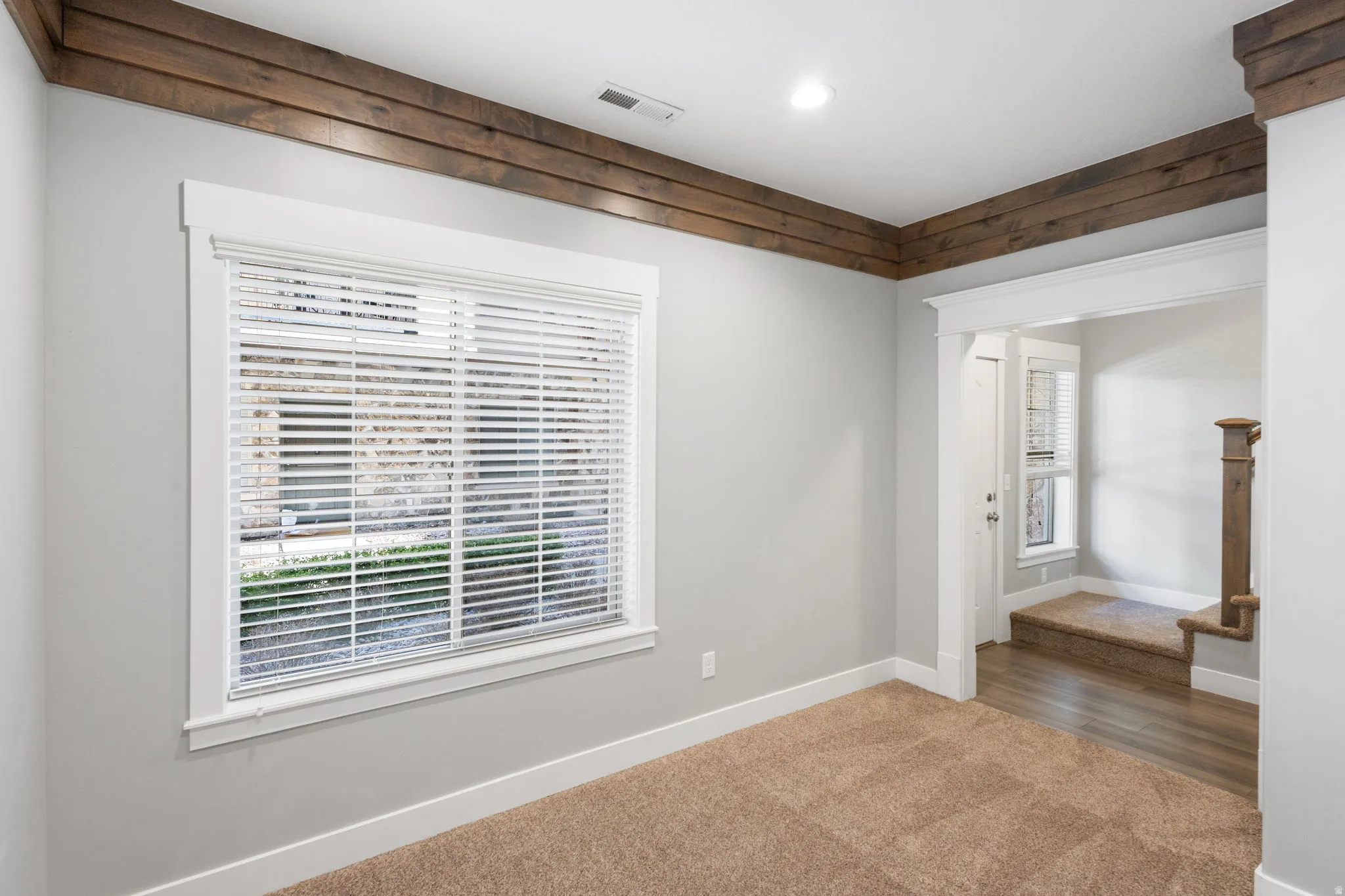 Carpeted empty room with baseboards and recessed lighting