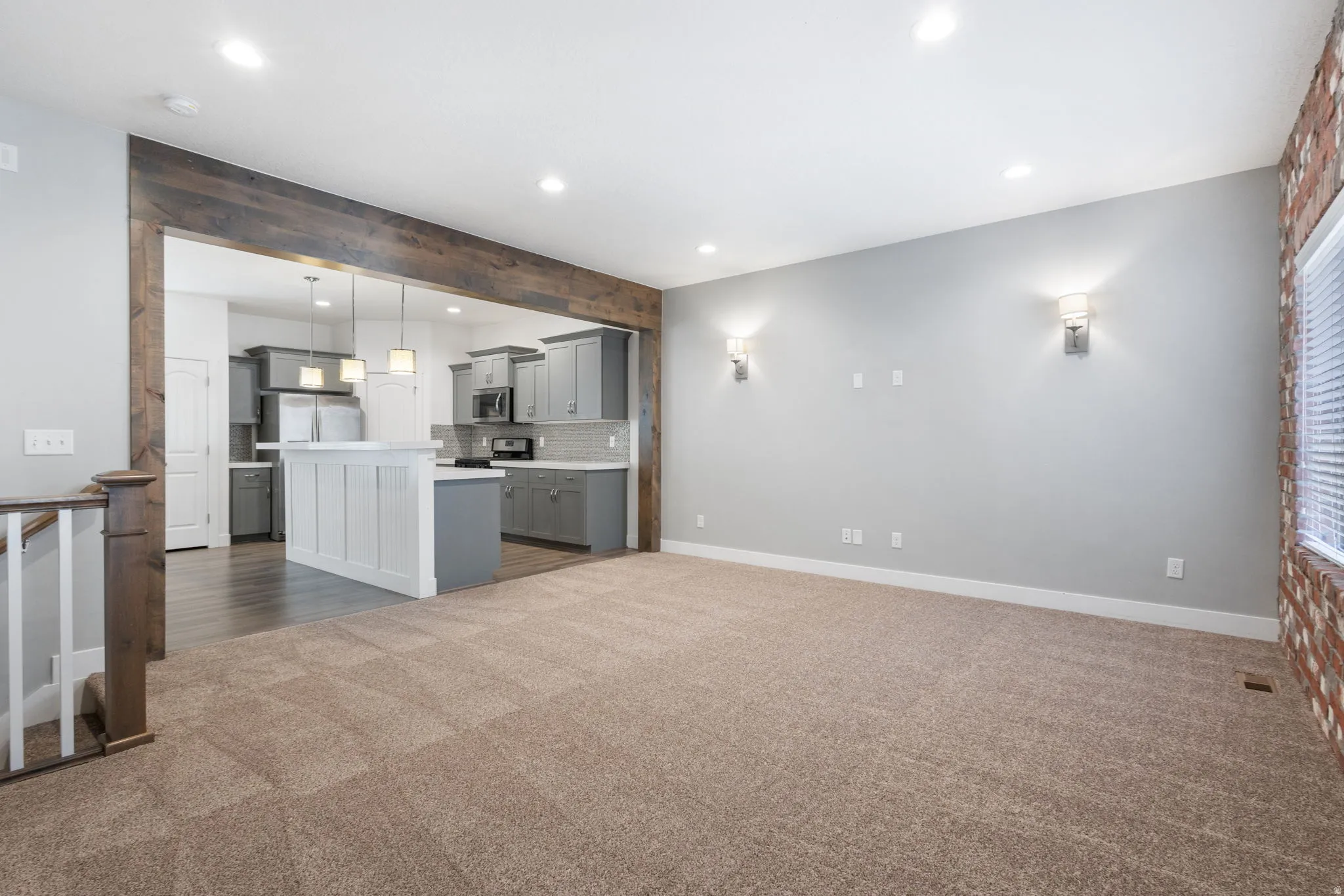 Unfurnished living room featuring dark colored carpet and recessed lighting