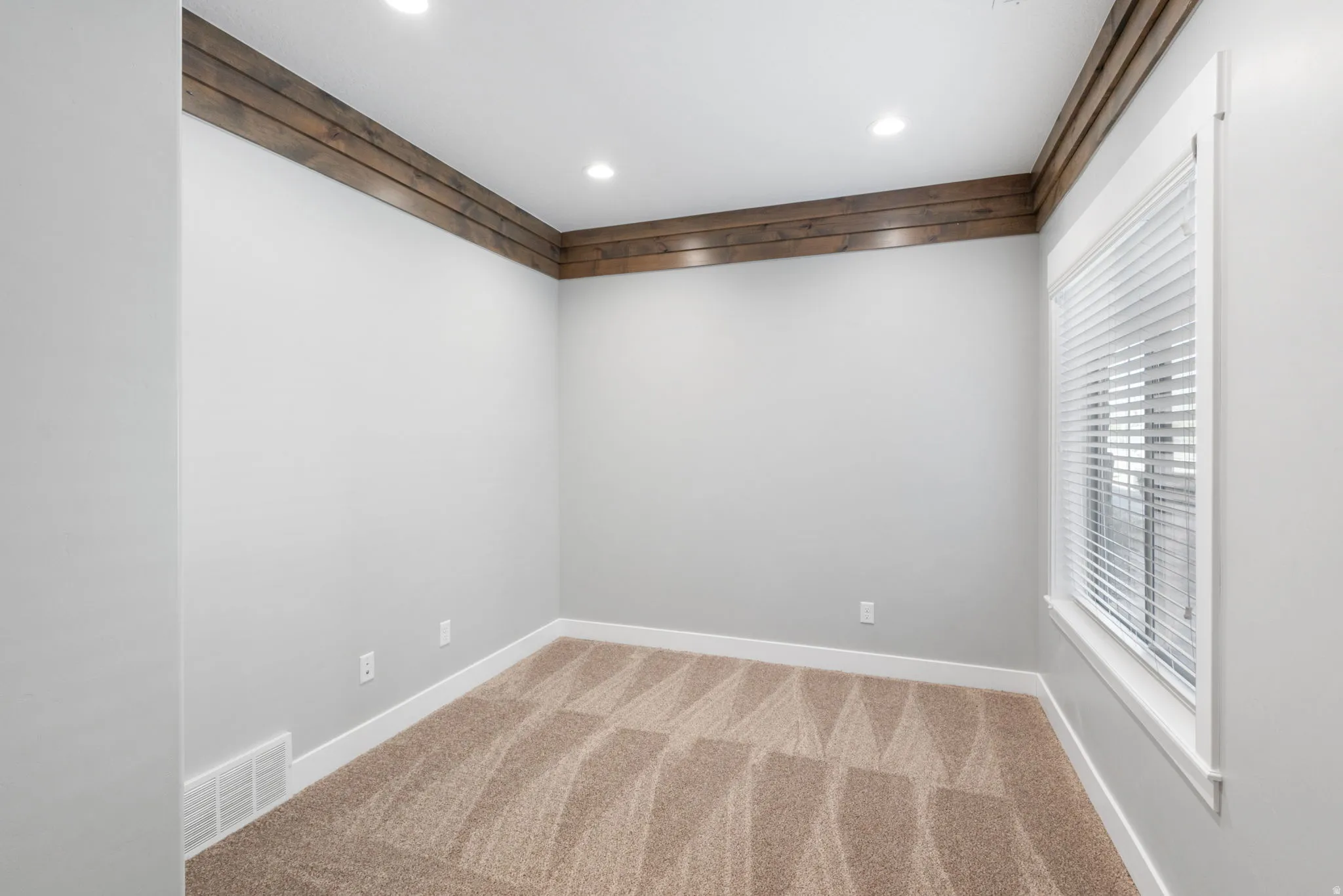 Unfurnished room with light carpet and recessed lighting